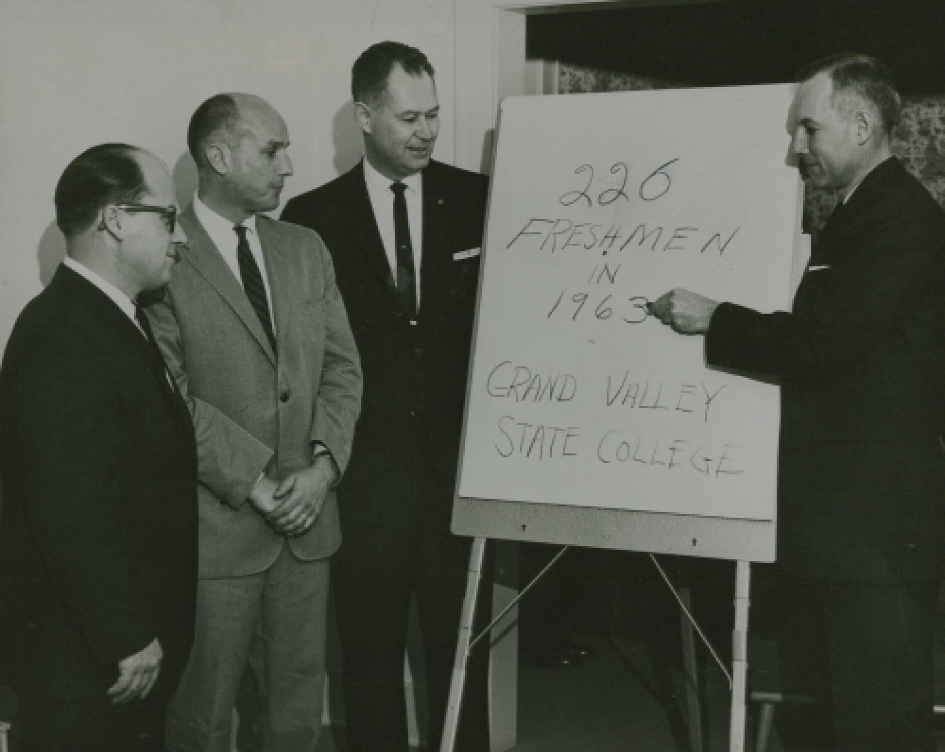 Dr. Arnold C. Ott (left) plans the future Grand Valley State University